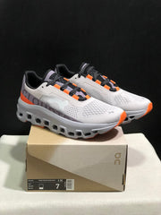 On Cloudmonster Sneakers in Foggy White and Orange