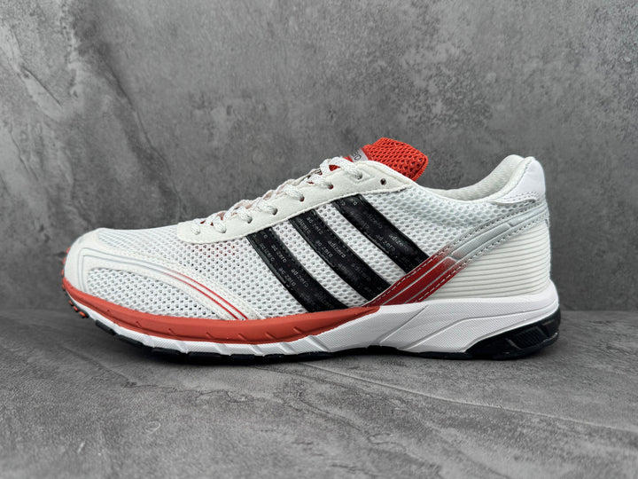 Adidas White Mesh Sneakers with Black Stripes and Coral Accents